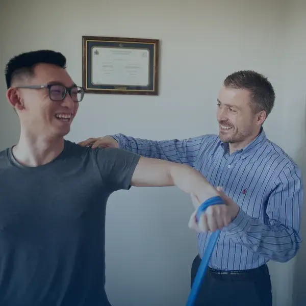 A man being taught home rehabilitations exercises.
