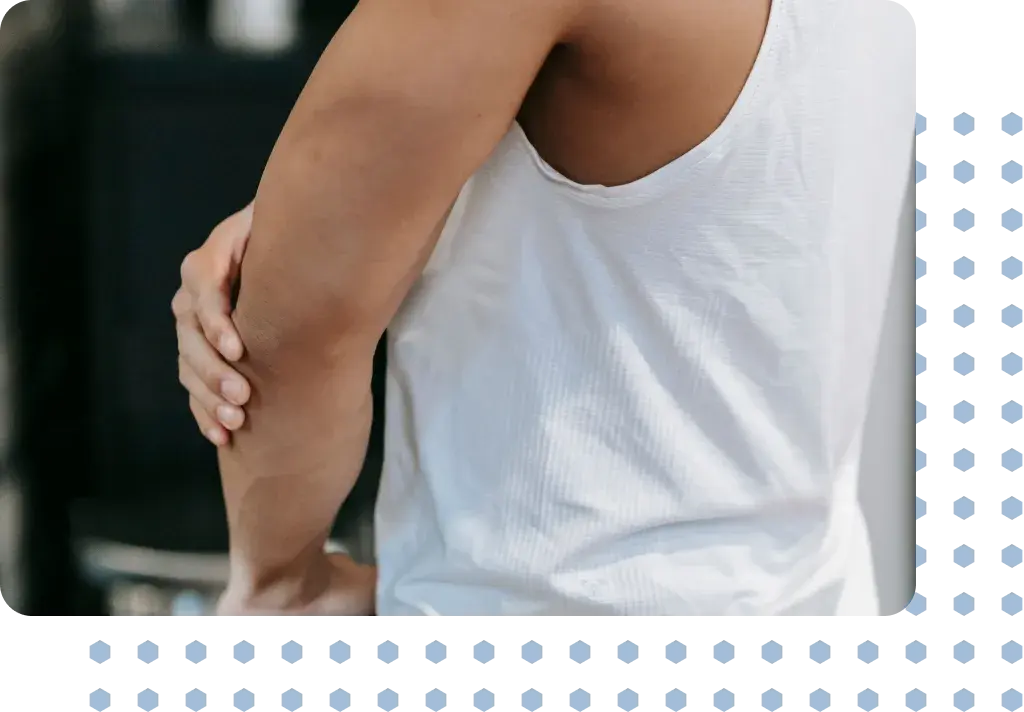 A man in pain holding his elbow