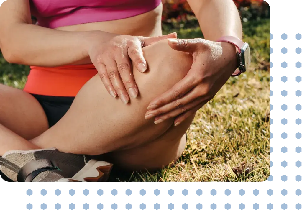 A woman in pain holding her knee