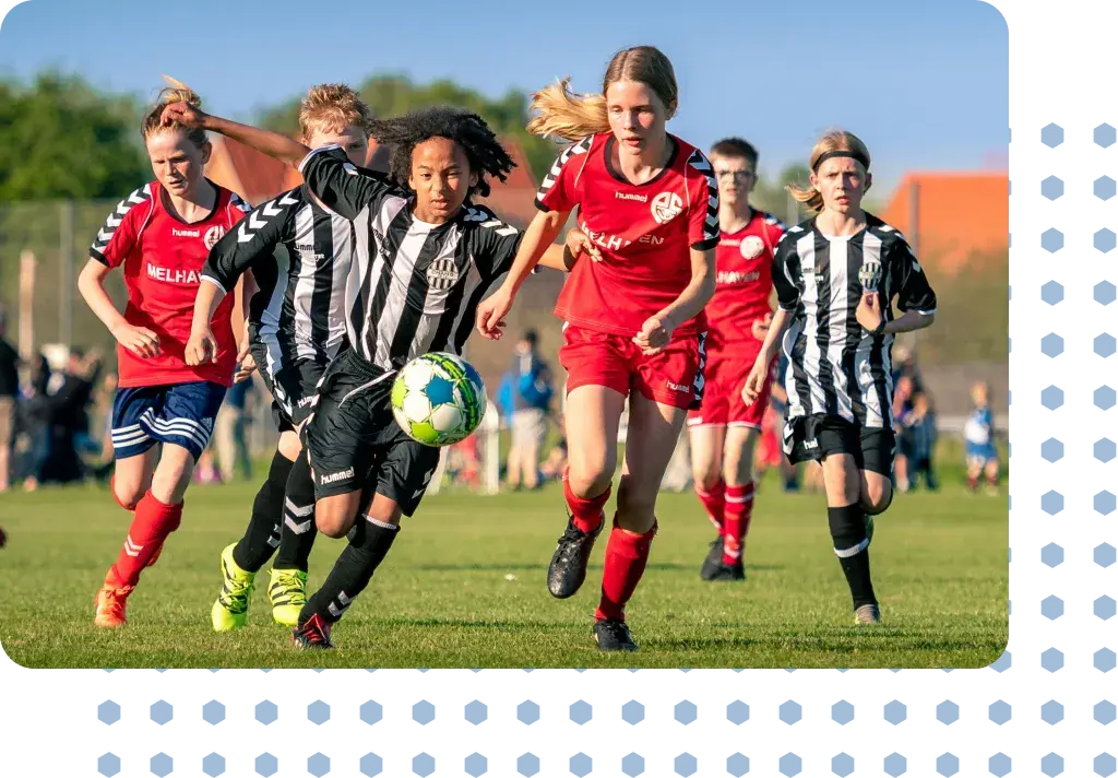 Teenage girls playing a game of football