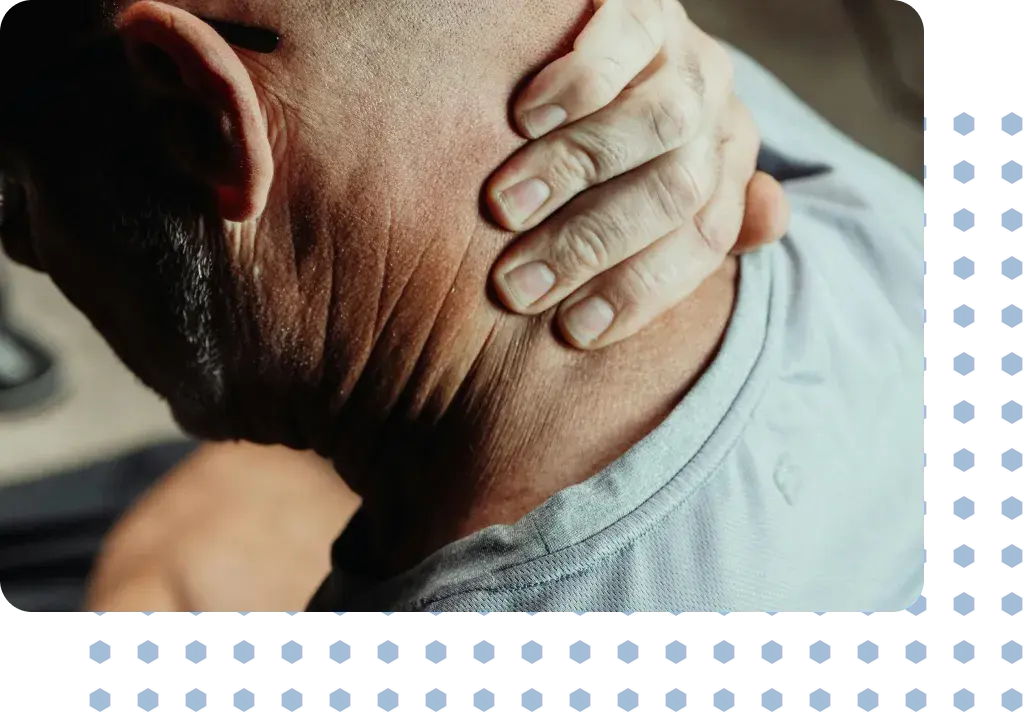 A man suffering from whiplash holding his neck