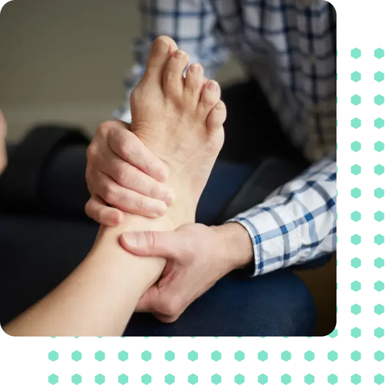 A male foot receiving chiropractic manipulation.