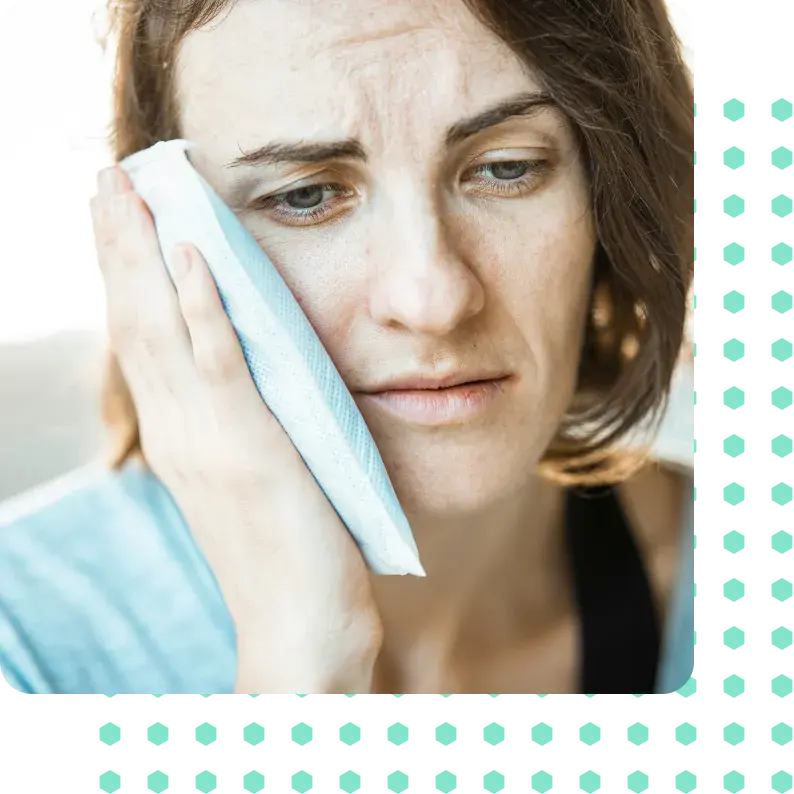 A woman icing her jaw.