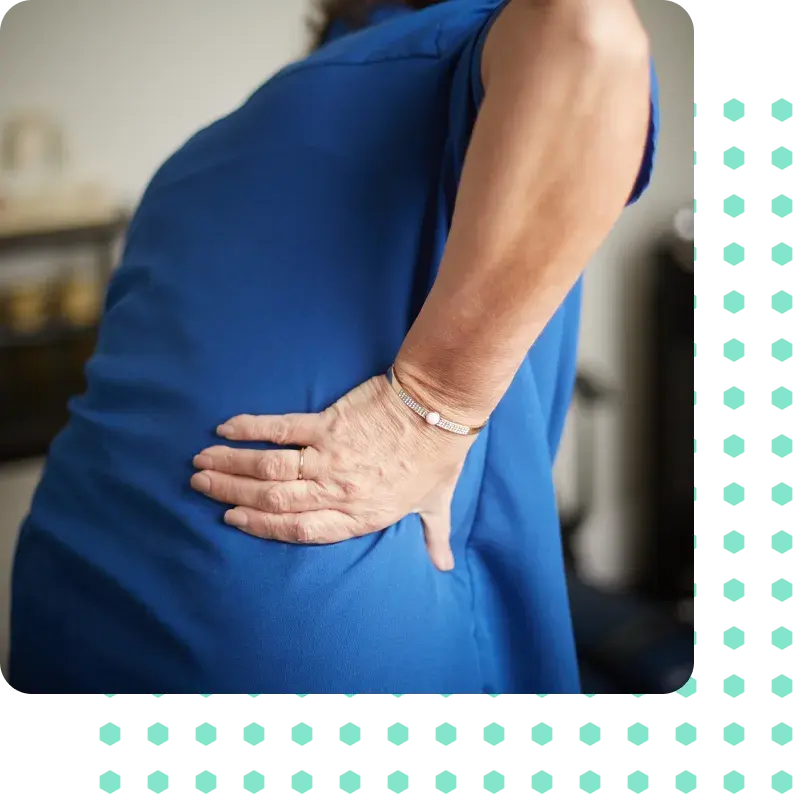 A woman holding her back in pain.