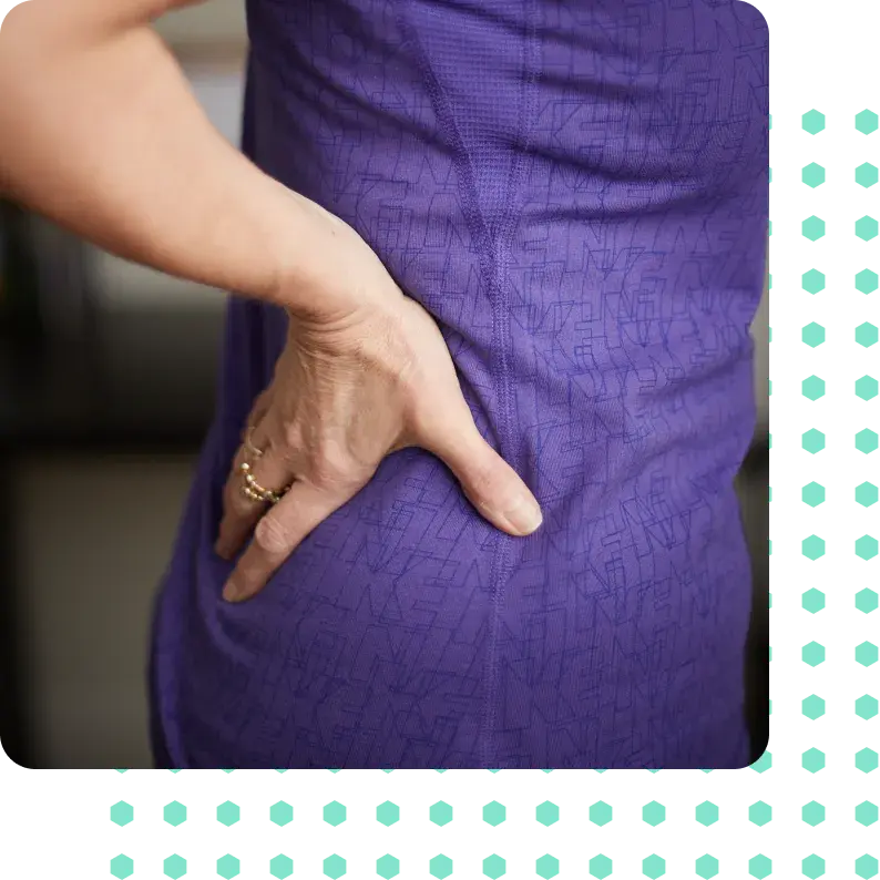 A woman holding her back in pain.