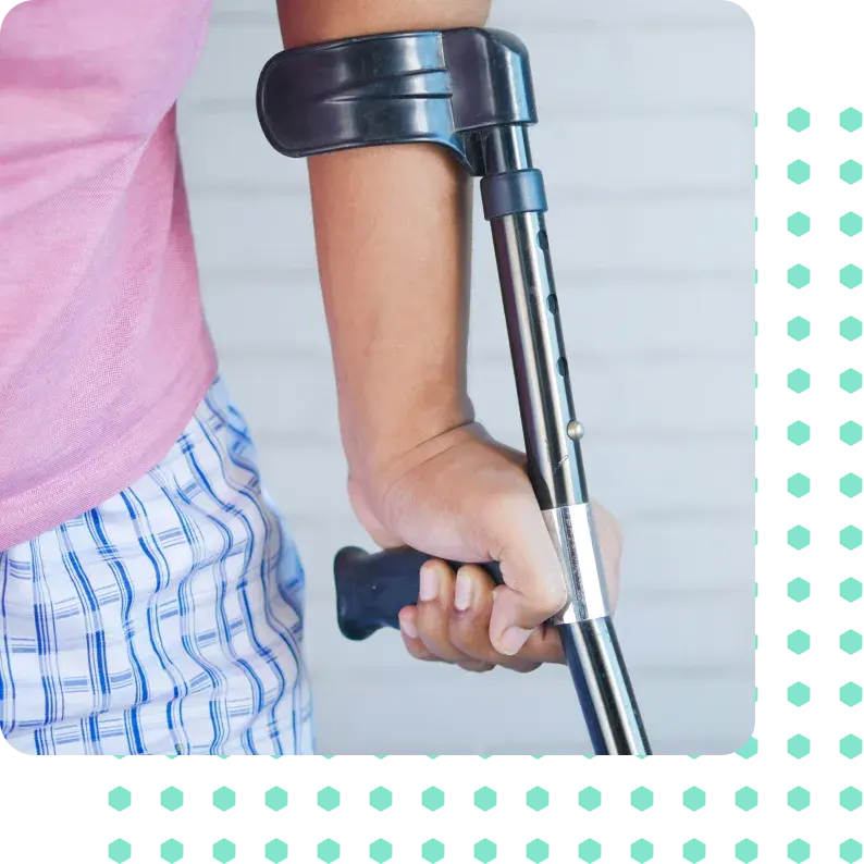 A man supporting himself with a crutch on his left side.