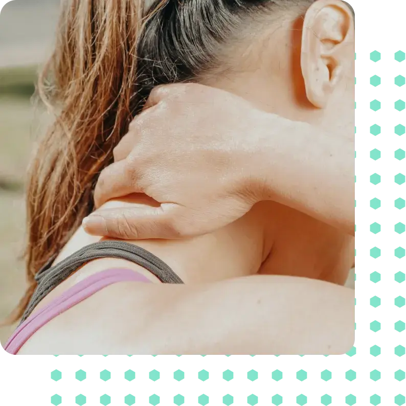 A young woman holding her neck in pain.