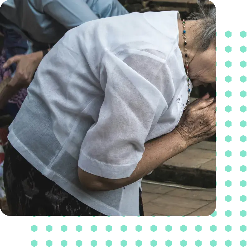 A woman suffering from osteoarthritis bent over in pain.