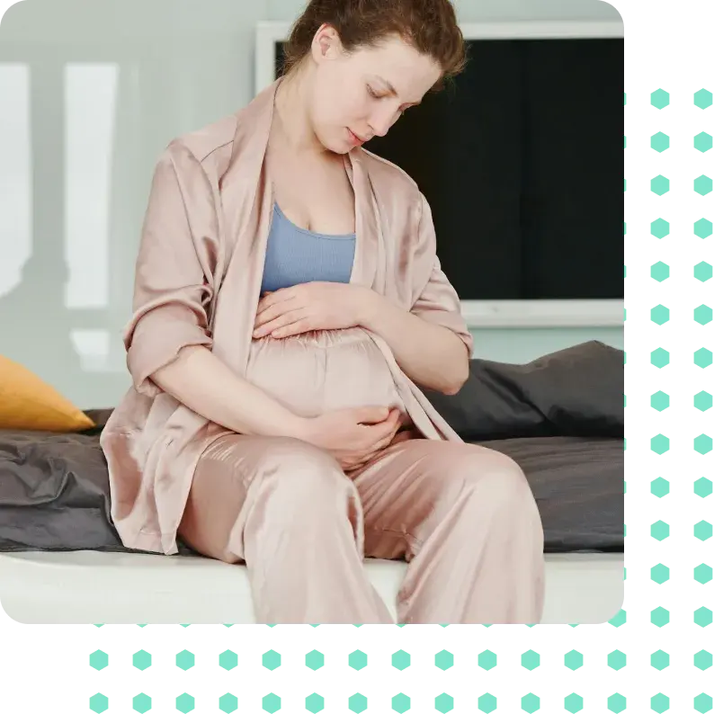 A pregnant woman holding her baby bump.