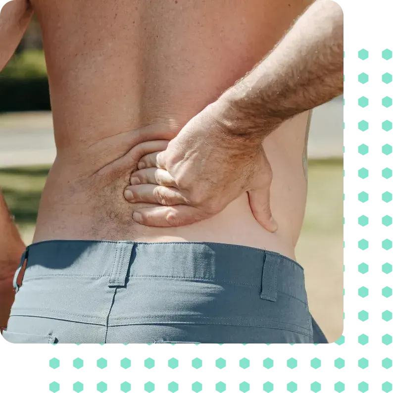 A man holding his back in pain.